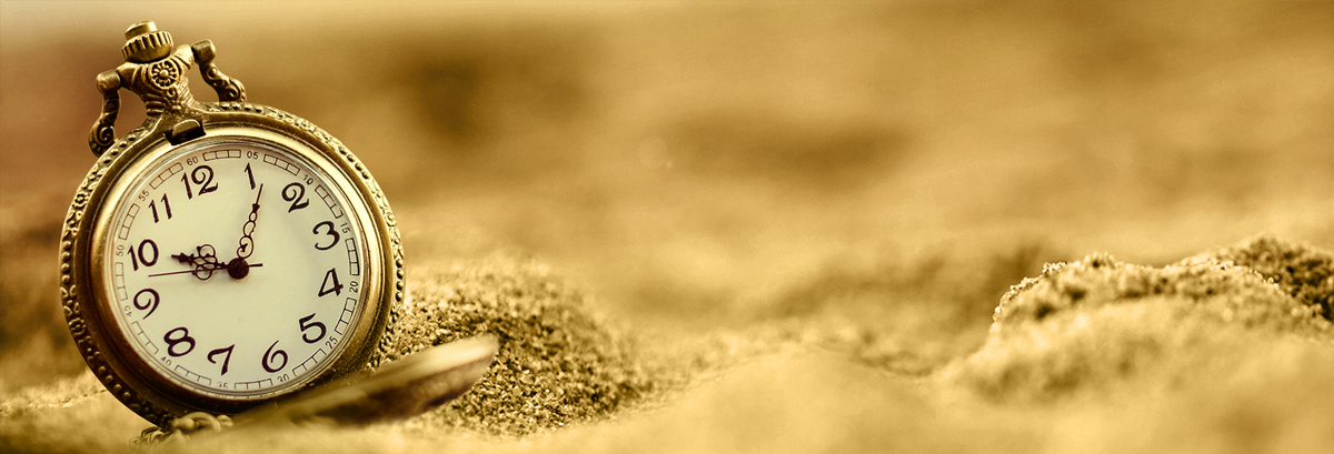 Personal Banking Account Page Banner AR-EN 1200x409px a close up of a TIME DEVICE in sand
